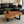 Laden Sie das Bild in den Galerie-Viewer, Akazie-Baumscheibe-Couchtisch (110 × 100 × 43 cm, 9 cm starke Platte) mit herzförmiger Wolken-Naturform, echter Baumkante und honigbrauner Maserung, Massivholz-Unikat für Wohnzimmer mit Ecksofa oder L-Sofa in der Schweiz
