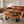 Laden Sie das Bild in den Galerie-Viewer, Ovaler Baumstamm-Couchtisch aus Akazie-Baumscheibe (Suarholz, 110 x 75 x 43 cm, 8 cm starke Platte) mit Naturkante, Massivholz-Unikat für Wohnzimmer, Lounge oder Wintergarten in der Schweiz
