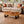 Charger l'image dans la galerie, Ovaler Baumstamm-Couchtisch aus Akazie-Baumscheibe (Suarholz, 110 x 75 x 43 cm, 8 cm starke Platte) mit Naturkante, Massivholz-Unikat für Wohnzimmer, Lounge oder Wintergarten in der Schweiz
