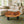 Laden Sie das Bild in den Galerie-Viewer, Baumscheiben-Designertisch aus massiver Akazien-Baumscheibe (110 x 75 x 43 cm, ca. 8 cm starke Platte) mit Natur-Loch, unregelmäßiger organischer Form und lebendiger Maserung, naturbelassenes Holzstamm-Unikat als Couchtisch für Lounge, Wohnzimmer oder überdachte Gartenlounge in der Schweiz
