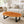 Laden Sie das Bild in den Galerie-Viewer, Ovaler Holzstamm-Couchtisch aus massiver Akazien-Baumscheibe (114 x 67 x 43 cm, ca. 8 cm starke Platte) mit Baumkante und sichtbaren Jahresringen, Naturholz-Unikat als Wohnzimmertisch für L-Sofa, Lounge-Ecke oder offenen Wohn-/Essbereich in der Schweiz
