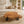 Laden Sie das Bild in den Galerie-Viewer, Couchtisch aus 9 cm starker Akazien-Baumscheibe (110 × 100 × 43 cm) mit rundlich-organischer Form, sanfter Einbuchtung, Naturriss und echter Baumkante, massives Naturholz-Unikat für Wohnzimmer mit L-Sofa, Familien-Lounge oder Meditations-Ecke in der Schweiz
