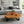 Laden Sie das Bild in den Galerie-Viewer, Holzstamm-Salontisch aus massiver Akazien-Baumscheibe (107 x 100 x 43 cm, 8 cm starke Platte) mit organischer Naturform und sichtbaren Jahresringen, naturbelassenes Massivholz-Unikat als Couchtisch für Wohnzimmer, Leseecke oder Wintergarten in der Schweiz`


