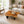 Load image into Gallery viewer, Salontisch aus massiver Akazie-Baumscheibe (95 x 92 x 43 cm, 8 cm starke Platte) mit Naturkante und organischer Form, kompakter Naturholz-Couchtisch im asiatisch inspirierten Stil für kleine Wohnzimmer in der Schweiz
