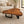 Laden Sie das Bild in den Galerie-Viewer, Tisch aus einem Baumstamm aus massiver Akazien-Baumscheibe (113 × 87 × 43 cm, ca. 8 cm starke Platte) mit organischer Naturform und sichtbarer Baumstamm-Struktur, pflegeleichtes Naturholz-Unikat als Couchtisch für Wohnzimmer, Lounge oder Wintergarten in der Schweiz
