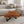 Load image into Gallery viewer, Baumstamm-Couchtisch aus umweltfreundlicher Akazien-Baumscheibe (100 x 90 x 43 cm, ca. 8 cm starke Platte) mit unregelmäßiger Naturform, lebendiger Maserung und echter Baumkante, pflegeleichtes Massivholz-Unikat für Wohnzimmer, Wintergarten oder Büro-Empfang in der Schweiz
