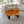 Charger l'image dans la galerie, Ovaler Baumstamm-Couchtisch aus Akazie (Suarholz-Baumscheibe, 113 x 80 x 43 cm, 8 cm stark) mit Naturkante und Baumloch, Massivholz-Unikat für Wohnzimmer, Lounge oder Wintergarten in der Schweiz
