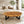 Load image into Gallery viewer, Großer Massivholz-Couchtisch aus Akazie-Baumscheibe (130 x 65 x 43 cm, ca. 8 cm starke Platte) mit zwei Baumkernen, breiter Baumstamm-Salontisch für Ecksofa, Familien-Sitzgruppe oder Loft-Wohnzimmer in der Schweiz
