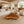 Load image into Gallery viewer, Baumscheiben-Couchtisch aus 9 cm starker Akazien-Baumscheibe (114 × 110 × 43 cm) mit organischer Dreiecksform und echter Baumkante, massives Naturholz-Unikat als Wohnzimmertisch für L-Sofa, Lounge oder Design-Wohnzimmer in der Schweiz
