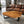 Laden Sie das Bild in den Galerie-Viewer, Holzstamm-Couchtisch aus massiver Akazien-Baumscheibe (126 x 86 x 43 cm, ca. 8 cm starke Platte) mit weißer Baumkante, unregelmäßiger Naturform und sichtbaren Jahresringen, großer Baumstamm-Salontisch für Sofalandschaft, Lounge oder Chalet-Wohnzimmer in der Schweiz

