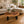 Load image into Gallery viewer, Baumscheiben-Designertisch aus massiver Akazien-Baumscheibe (110 x 75 x 43 cm, ca. 8 cm starke Platte) mit Natur-Loch, unregelmäßiger organischer Form und lebendiger Maserung, naturbelassenes Holzstamm-Unikat als Couchtisch für Lounge, Wohnzimmer oder überdachte Gartenlounge in der Schweiz`
